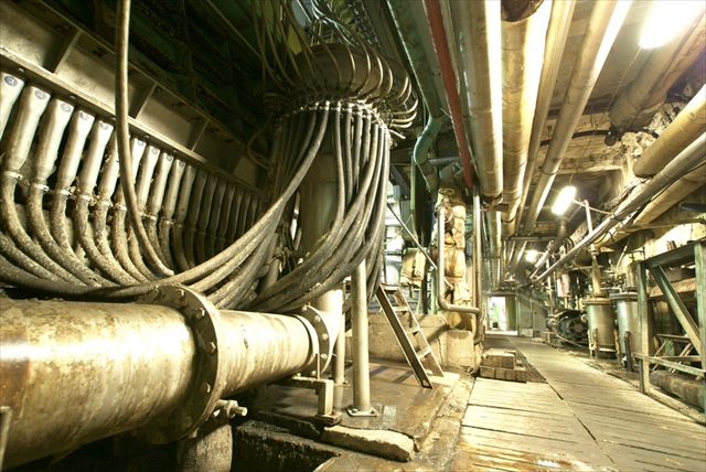 Equipment, cables and piping as found inside of  industrial power plant
